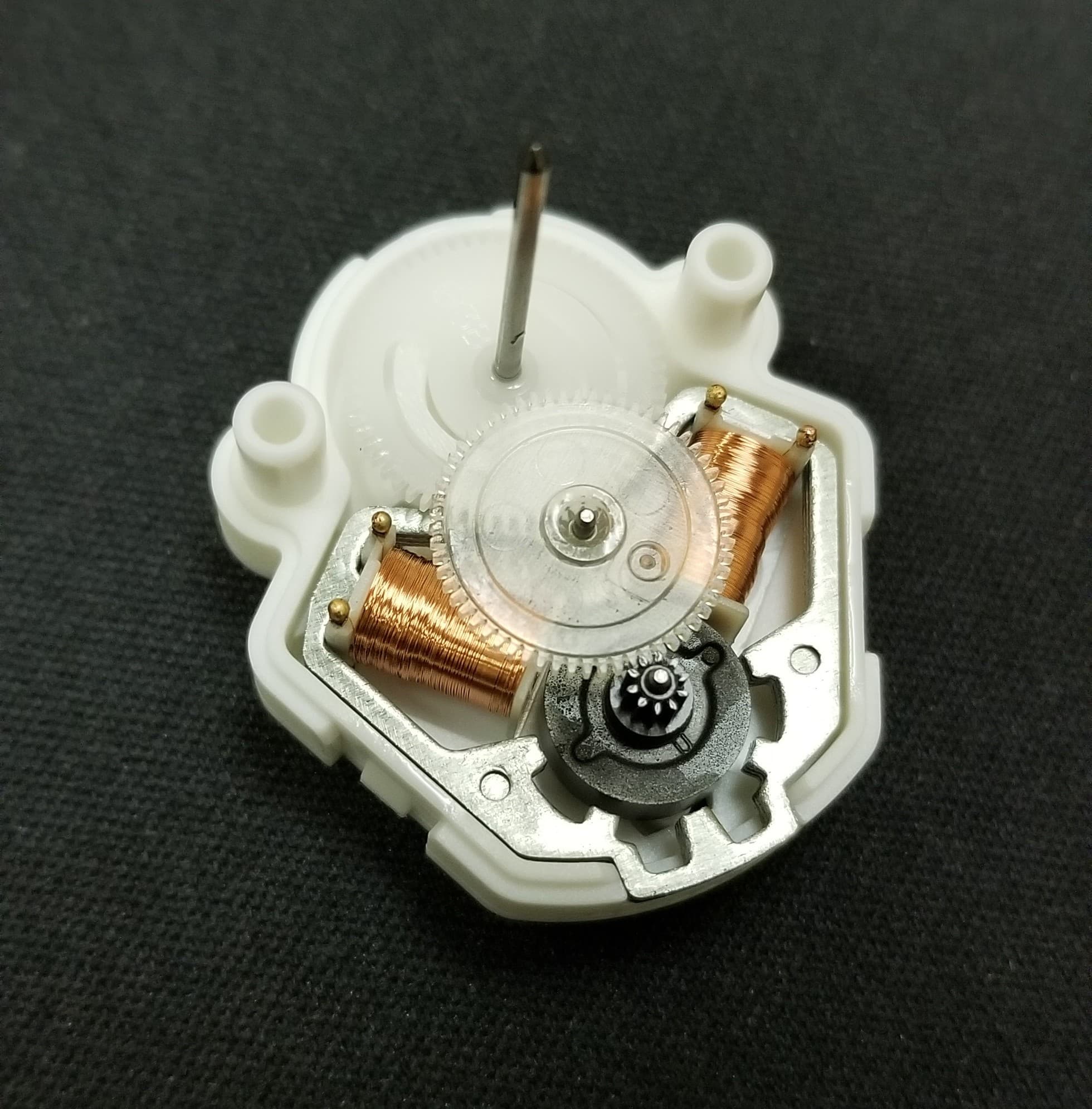 Automated stepper motor manufacturing cell with coil winding and assembly stations